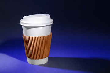 Takeaway paper cup on dark color background