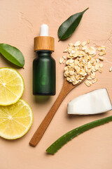 Bottle of natural serum, spoon with oat flakes, plant leaves, coconut and lemon slices on beige background