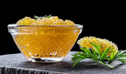 Pike caviar or roe in the bowl on wooden background.