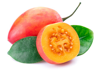 Ripe tamarillo fruits with slices and tamarillo leaves isolated on a white background.