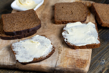 slices of black sliced bread with butter spread from milk