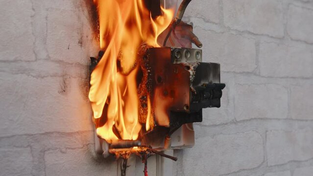 Circuit breaker fire in switch box indoors. Fault contact switching device, malfunction electrical wiring, short circuit, overload.
