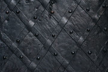 Old forged black metal door with stripes and rivets of the Boim chapel in Lviv, Ukraine. Vintage...