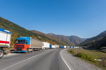 Trucks on roadside near mountains