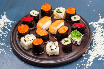 Sushi set on cutting board. Rice on the table.