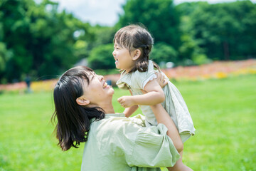 mother and her daughter hugging in the park