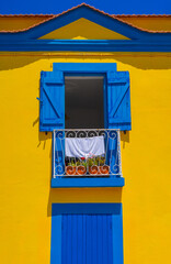 Fototapeta na wymiar Close-up of Typical portugal multicolored yellow and blue house in Aveiro city