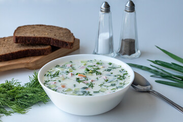 Okroshka, summer, cold soup with vegetables, fresh herbs and kefir. Rassian food. Traditional...