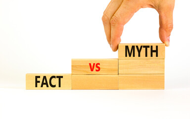 Fact vs myth symbol. Concept words Fact vs myth on wooden blocks on a beautiful white table white background. Businessman hand. Business, finacial and fact vs myth concept. Copy space.