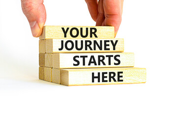 Your journey starts here symbol. Concept words Your journey starts here on wooden blocks on a beautiful white table white background. Business, motivational and your journey starts here concept.