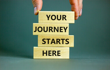 Your journey starts here symbol. Concept words Your journey starts here on wooden blocks on a...