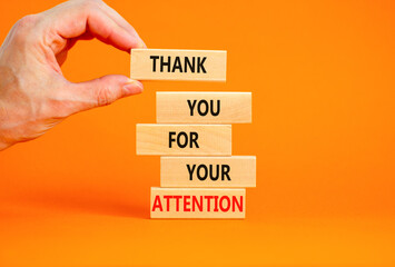 Thank you for attention symbol. Concept words Thank you for your attention on wooden blocks on beautiful orange table orange background. Businessman hand. Business and thank you for attention concept.