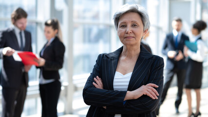 Mature businesswoman standing in office