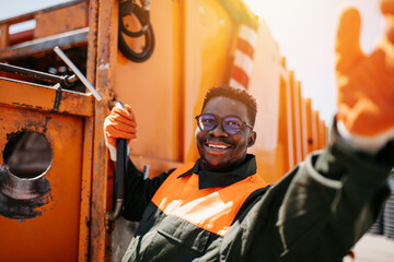 Portrait of a African American worker of the city utility company. Garbage collector. - obrazy, fototapety, plakaty