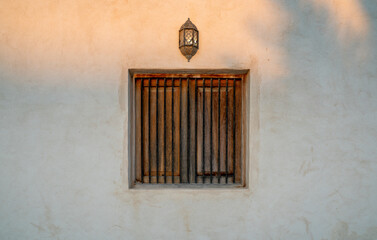 background image of old window and old wall lamp in qatar.. Arabic style