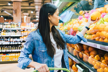 Young woman wearing casual outfit shopping for food