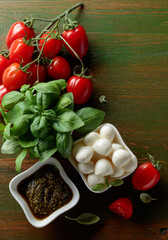 Mozzarella cheese with basil, pesto, and tomatoes.