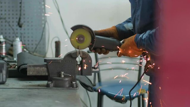 Collision auto repairs service. Mechanic grinding car body by grinder