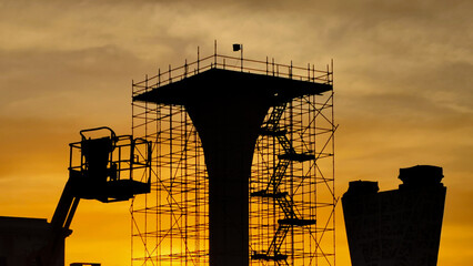 Silhouette of highway bridge construction.