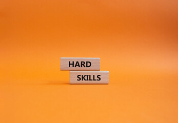 Hard skills symbol. Wooden blocks with words Hard skills. Beautiful orange background. Business and...