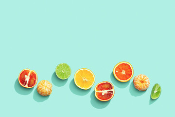 Citrus fruits as creative background, grapefruit, orange, tangerine, lemon, lime with shadow at sunlight on pastel mint background with copy space. Fruit food concept. Flat lay, top view - obrazy, fototapety, plakaty
