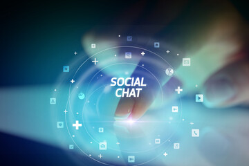 Finger touching tablet with social media icons concept