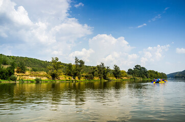 Dnister river landscape with people on sport catamaran, National Nature Park Dnister Canyon, Ukraine