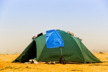 green tent at the sea beach © Petro Teslenko