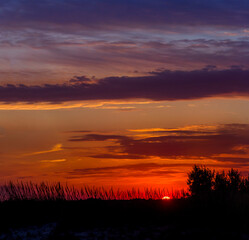 Obraz premium a sunset under the Ukrainian steppe near the Sea of Azov