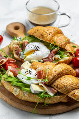 Variety of aperitifs Croissant sandwiches with jamon ham serrano paleta iberica, blue cheese,...