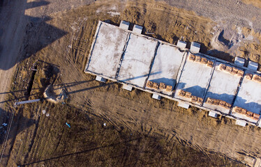 Aerial drone top down view on construction site with reinforced concrete house foundation