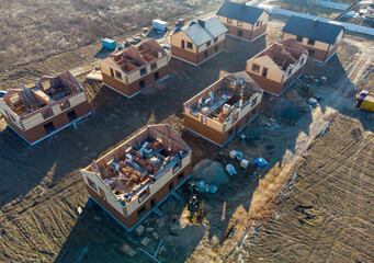 Fototapeta na wymiar Newly built homes in a residential estate. Construction of the building of brick.