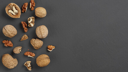 Fototapeta na wymiar walnuts in a white bowl on a matte gray background close-up, copy space, top view