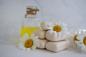 Obraz na płótnie Canvas natural soap, chamomile flower on a light background