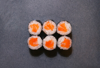 Top view rolls with salmon on a dark background