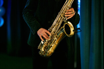 a man plays the saxophone, close-up of the hands. World Jazz Festival. Saxophone, a musical...