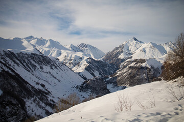 Alpine winter mountain landscape. French Alps covered with snow in sunny day. 