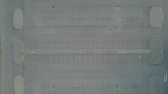 flying from above on a drone empty shopping mall parking lot asphalt summer at sunset. High quality 4k footage