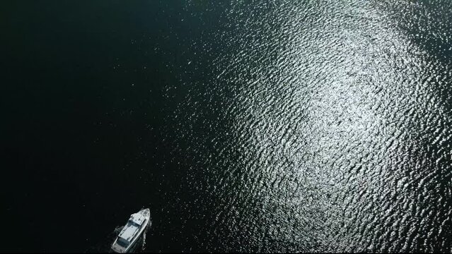 Motor boat powering away over calm sea in Stockholm archipelago