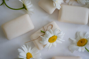 Fototapeta na wymiar natural soap, chamomile flower on a light background