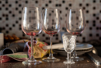 dirty glasses and a shot glass on the table after the party