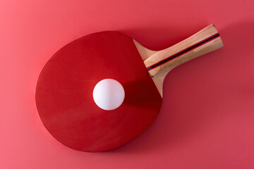 tennis racket for table tennis with a white ball on a pink background