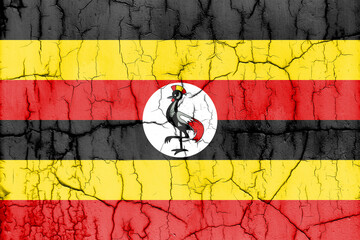 Textured photo of the flag of Uganda with cracks.