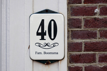 House number sign on a brick wall