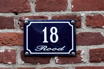 House number sign on a brick wall