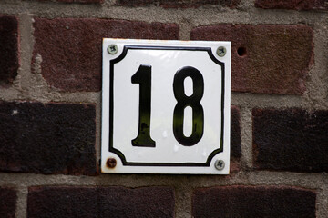 House number sign on a brick wall