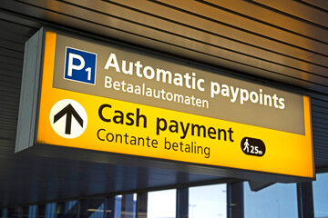 Travelers information at an airport where you can find a cash machine pay machine for Parking