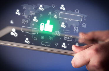 Close-up of a hand using tablet, social media concept