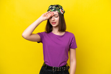 Young Ukrainian woman isolated on yellow background with tired and sick expression