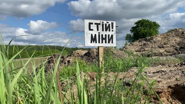 Danger, mines. War in Ukraine. Minefield. Sign caution stop mines in Ukrainian. Mined areas are life threatening. Military crisis. Russian aggression